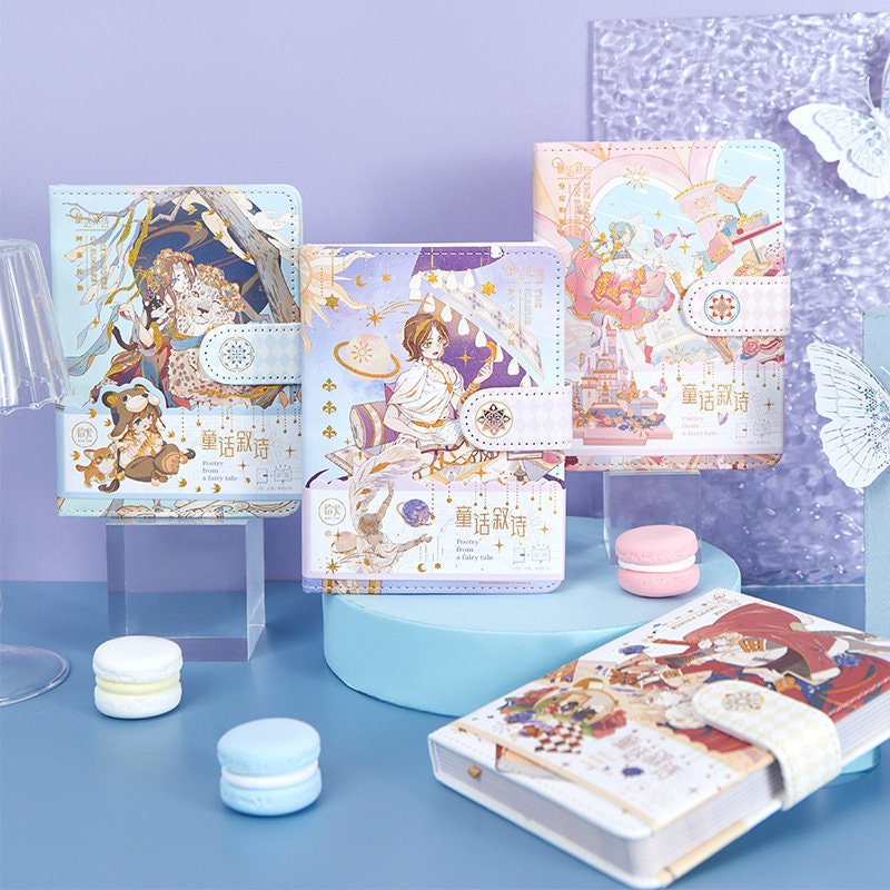 Fairy Tale Leather Journal - Magnetic Buckle A5 featuring enchanting fairy tale illustrations, displayed on a pastel-colored background with macaron props.