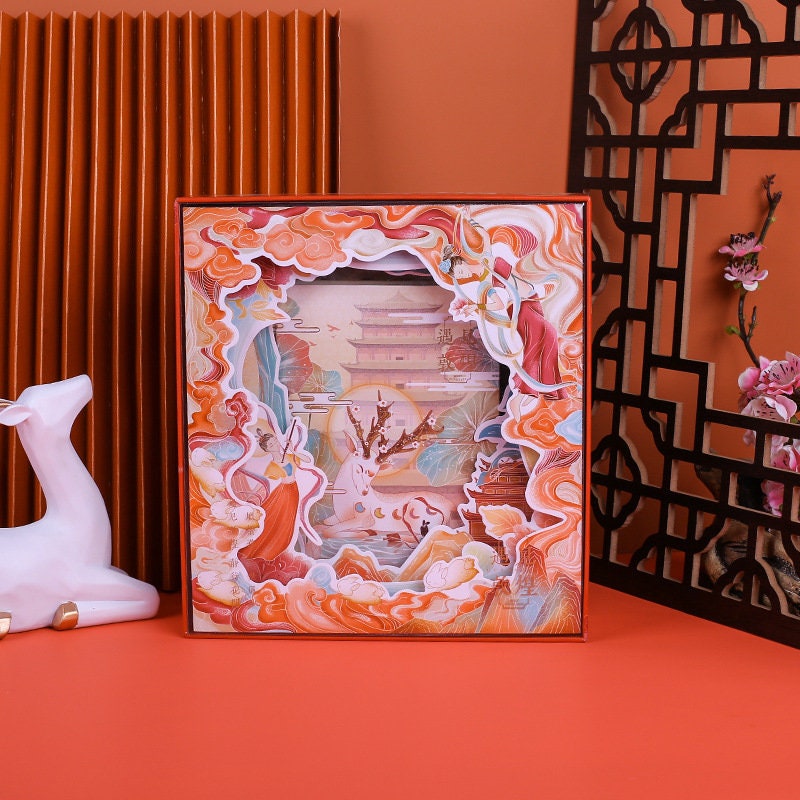 Blue Whale Notebook Set with Lighting Box featuring an intricate Asian-inspired design with vibrant colors, displayed on an orange background with a white deer figurine and floral elements.