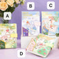 Dream Visionary Magnetic Buckle Leather Journal in pastel colors with whimsical illustrations, available in four designs (labeled A, B, C, D), displayed on a lavender background with roses nearby.