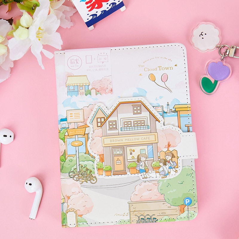 Magnetic Buckle Leather Journal - Cloud Town Design featuring a charming illustration of a small town with a café, children playing, and pastel colors, perfect for cute kawaii stationery lovers.