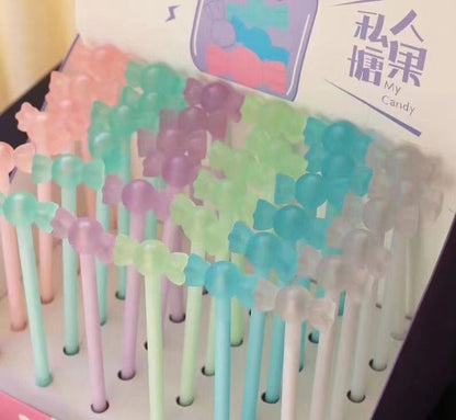 Kawaii black gel pen with 0.5mm micro point in pastel colors, featuring cute candy-shaped tops, displayed in packaging.