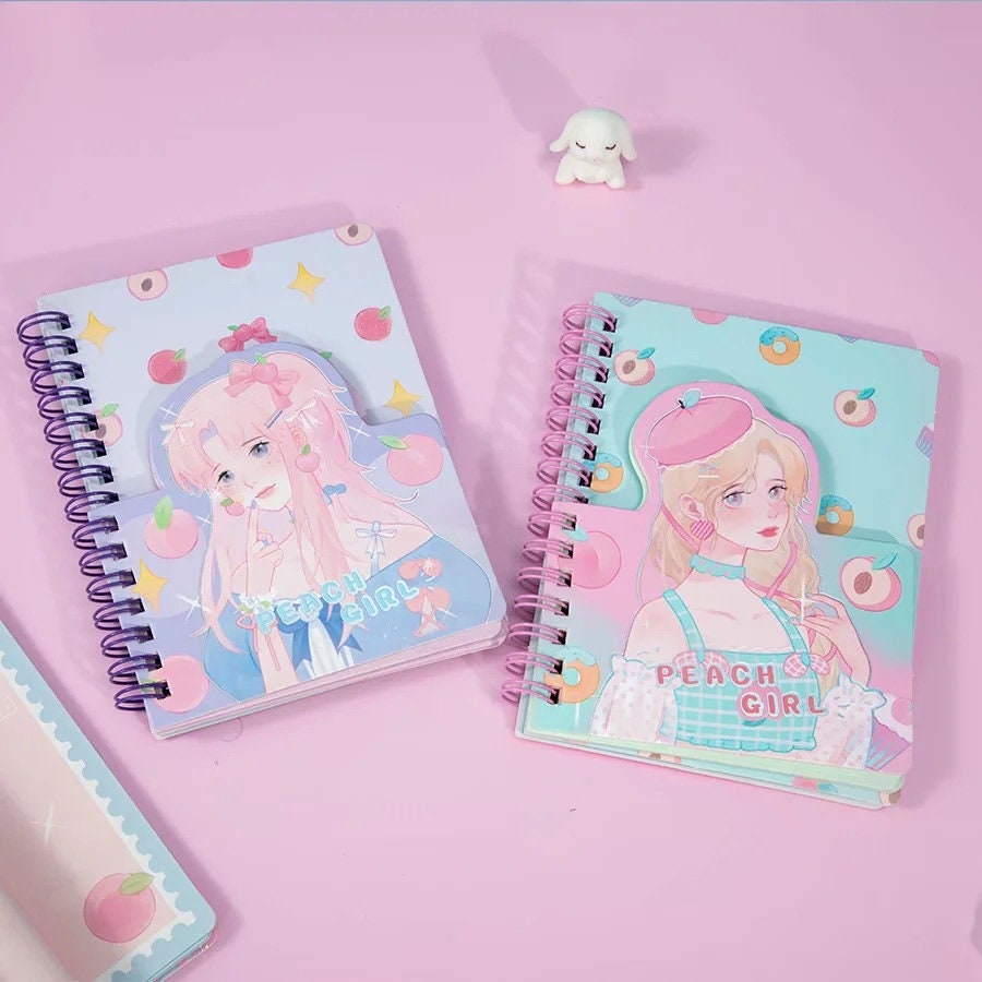 Kawaii Peach Girl Winding Journal with 180 Colorful Pages featuring cute anime girl illustrations, spiral binding, and peach-themed designs on a pink pastel background. Ideal for writing, note-taking, and sketching.