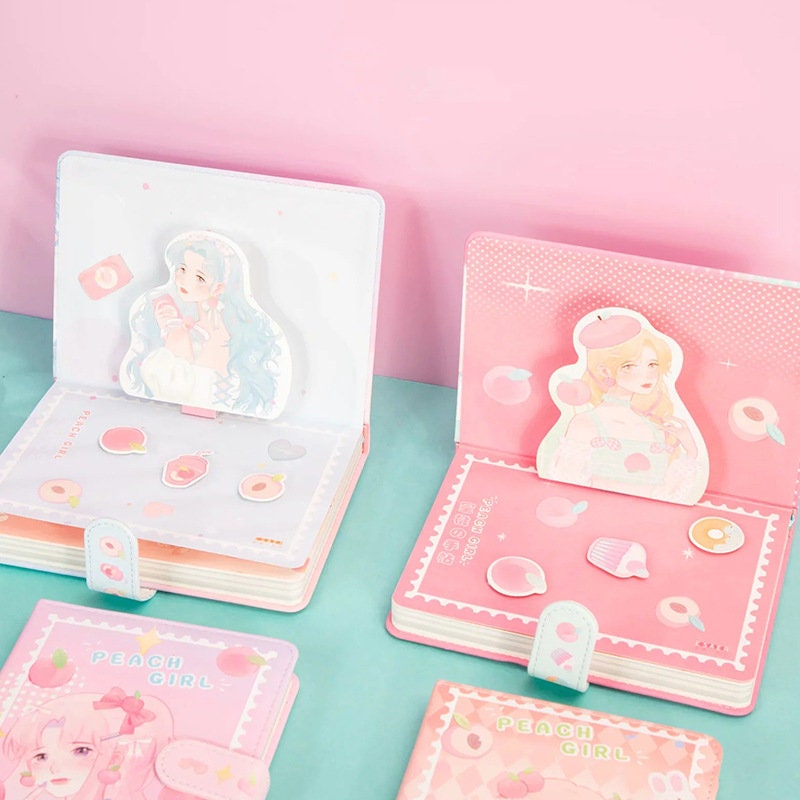 Kawaii Peach Girl Magnetic Journal with cute peach-themed illustrations and magnetic bookmarks on a pastel pink and blue page layout, perfect for stationery lovers.