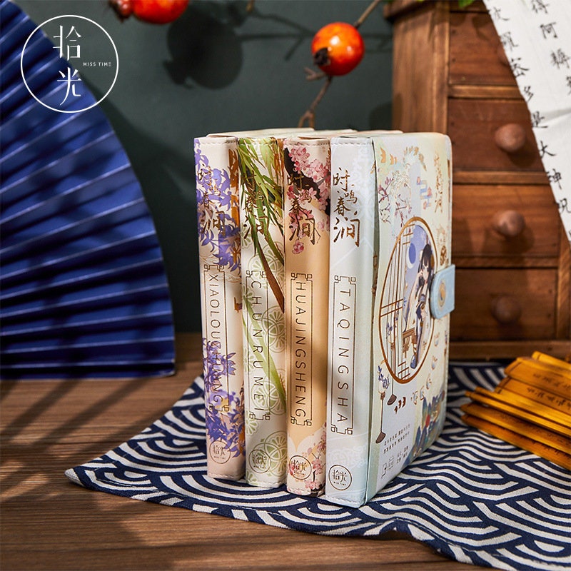 Spring Fairy Leather Journal - Anime Beauty A5 with floral and botanical spine designs, displayed on a wooden table with decorative elements.