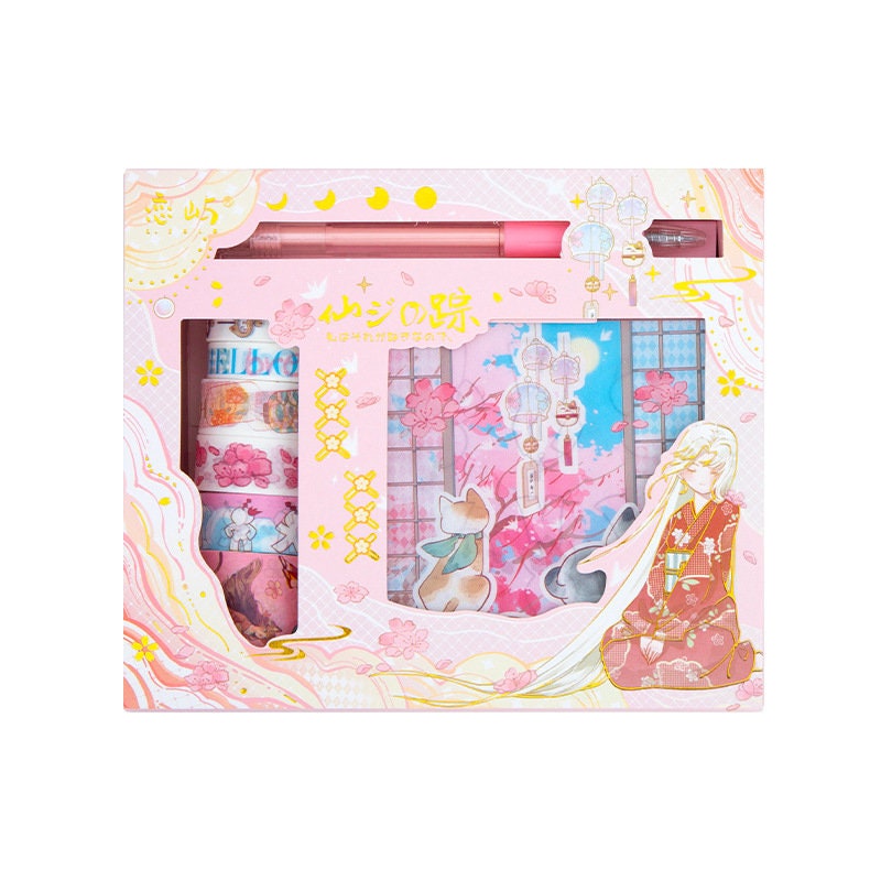 Fairyland Washi Tape Set in pastel pink packaging featuring whimsical designs, floral patterns, and a coordinating pen; ideal for craft and DIY projects