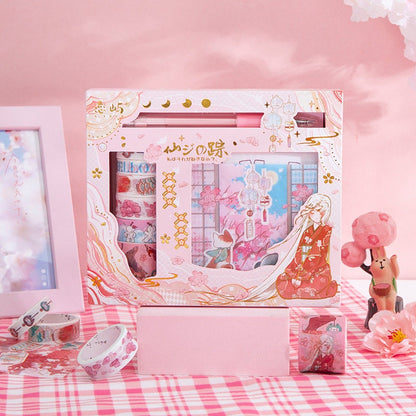 Fairyland Washi Tape Set - Craft and DIY Gift featuring various floral and pastel designs in a decorative box background; kawaii-style components including washi tape rolls, pen, and a miniature figure on a pink checkered tablecloth.