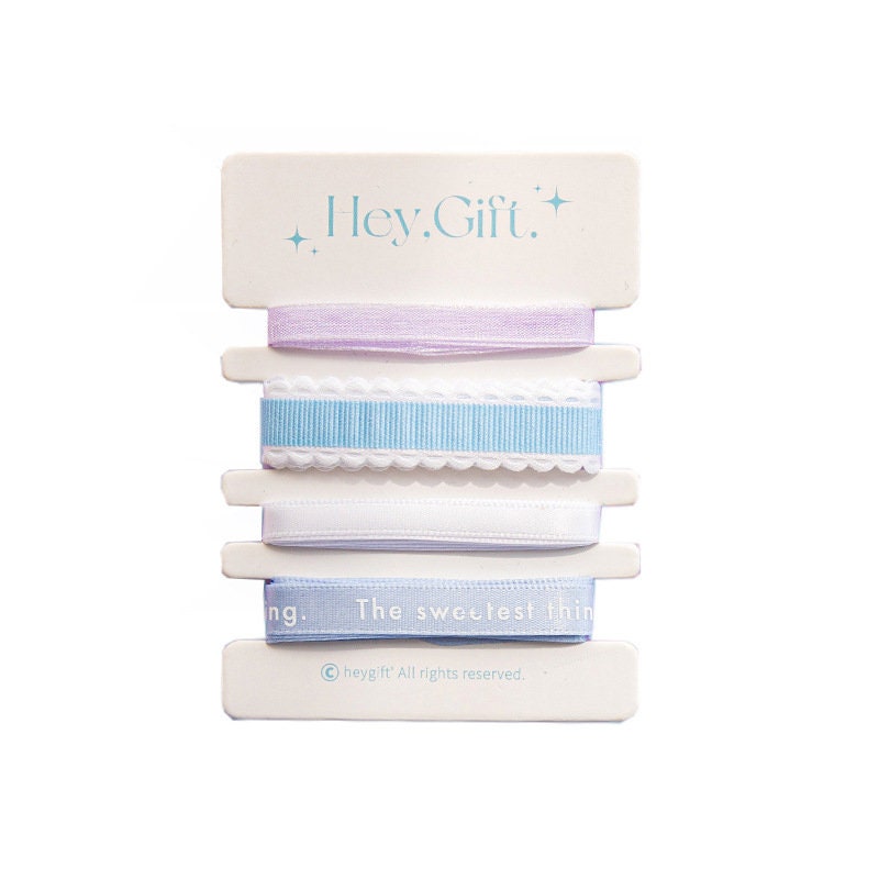 Gift wrapping ribbon set with stickers and cards, featuring pastel-colored ribbons in shades of lavender, white, and blue, ideal for kawaii stationery, crafts, and gift wrapping.