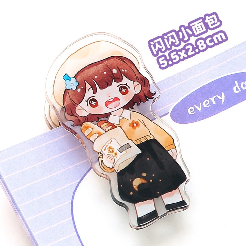 Kawaii girl paper clip featuring a cute anime character wearing a yellow sweater and black skirt, holding a bag with bread, perfect for office and school supplies.