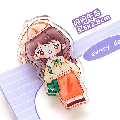 Kawaii girl paper clip featuring a cute, cartoon girl with a hat, green bag, and orange skirt, perfect for office and school supplies; 5.5x2.8cm size