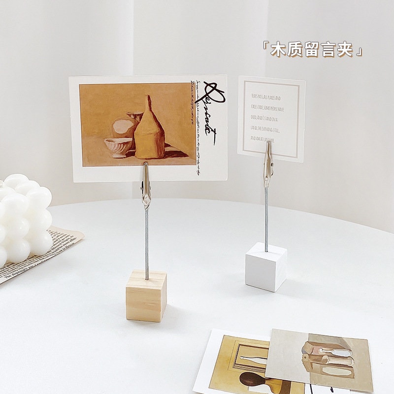 Creative Block Photo Holder with Clip in minimalist square design, perfect for displaying photos or notes, suitable for home or office decor, available in wood and white colors, featuring sturdy metal clips.