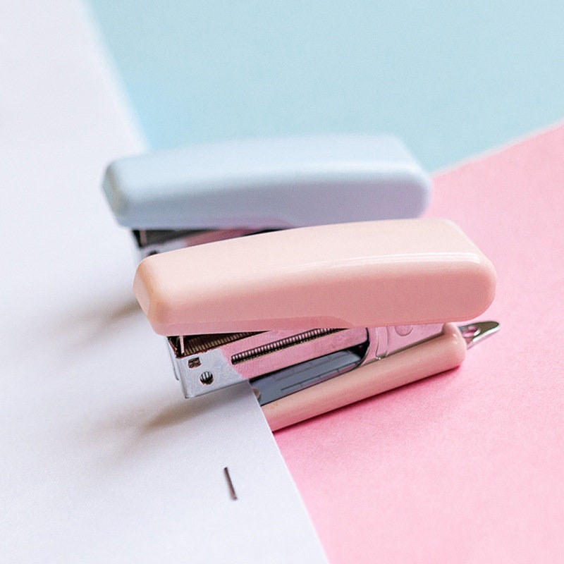 Pastel pink and blue nature-themed mini staplers, perfect for planners and scrapbooking, on a colorful background.