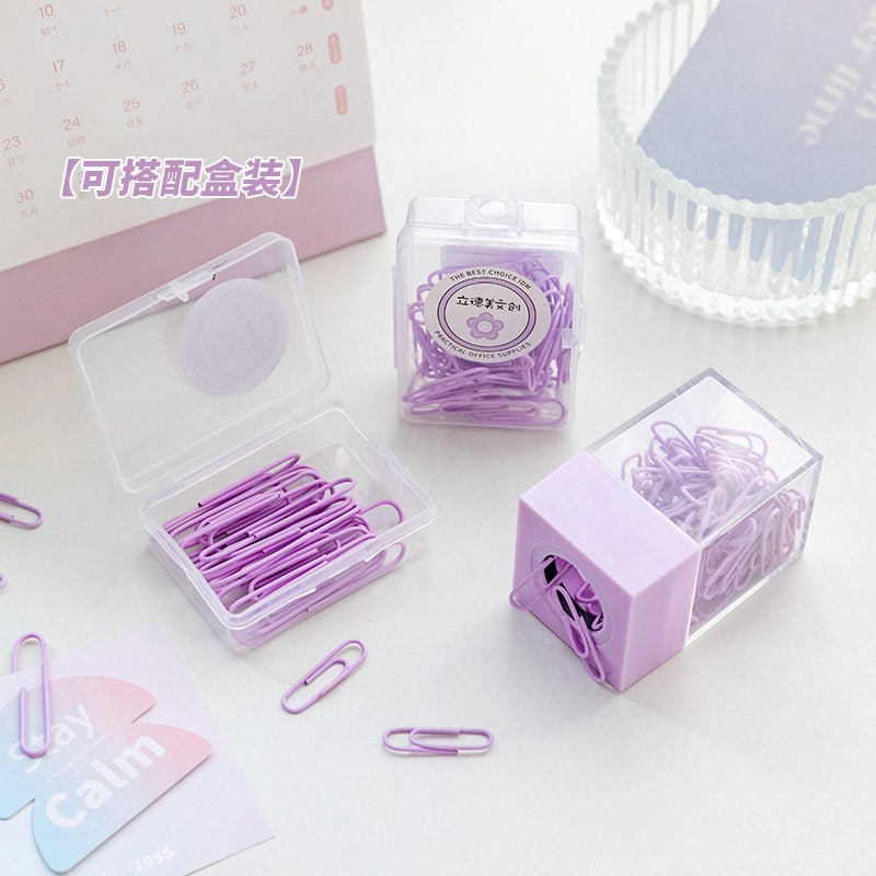 Pastel purple office paper clips in various clear plastic containers, perfect for organizing journals, books, and more.