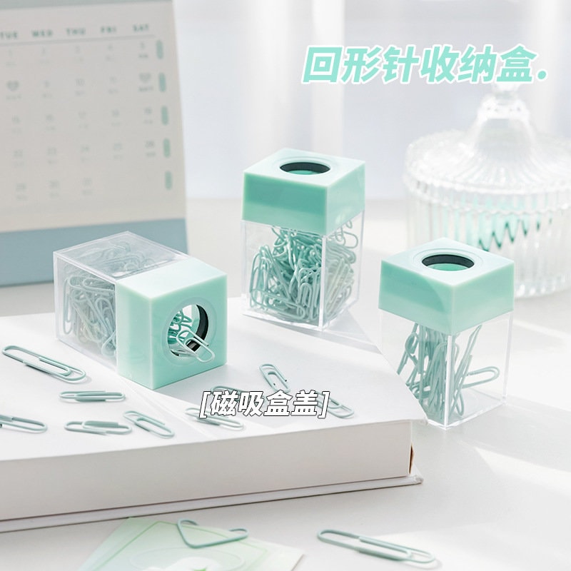 Pastel office paper clips in teal cube-shaped containers with magnetic lids, perfect for organizing journals, books, and other stationery.