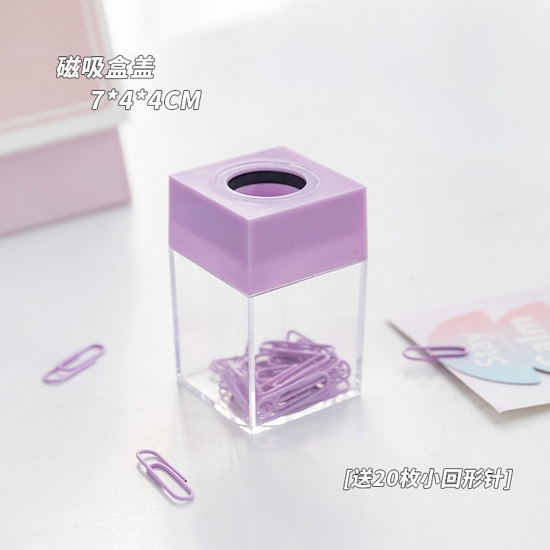 Pastel office paper clips in a transparent container with a lavender lid, perfect for organizing journals, books, and more.