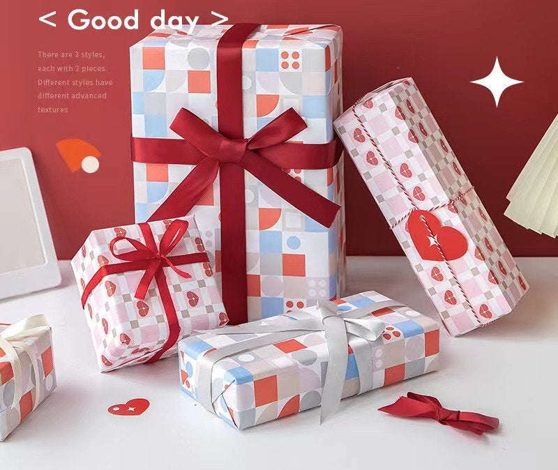 Vibrant patterned gift wrapping paper in colorful geometric designs on presents with red and silver ribbons, perfect for all occasions.