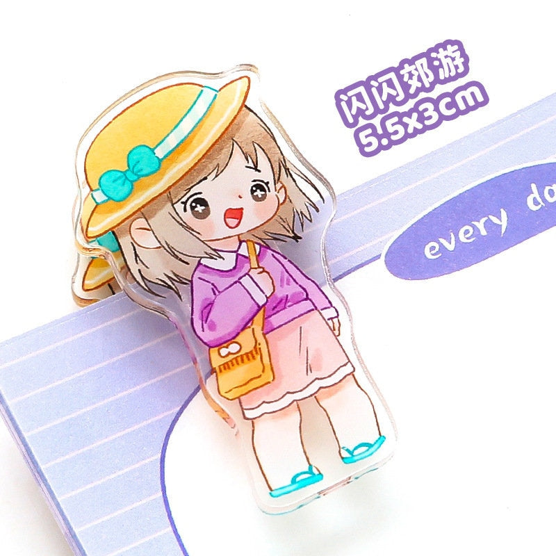 Kawaii girl paper clip in cute animated style, featuring a character with a yellow hat, purple sweater, and pink skirt. Perfect for organizing office and school supplies.