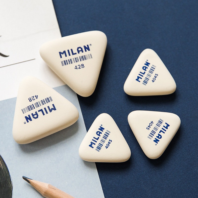 Milan Eraser - Cute and Chic in two sizes, featuring triangular shapes, perfect for school and office stationery. Multiple erasers displayed on a blue and white background with a pencil.