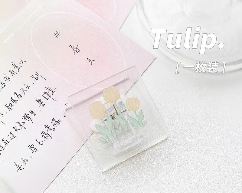 Cute floral decorative clip with yellow tulip design on pastel background - Creative kawaii office supply accessory.