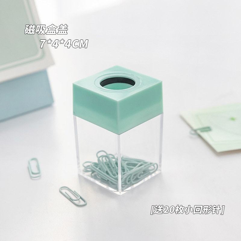 Pastel office paper clips in a cute pastel green dispenser, perfect for organizing journals, books, and more.