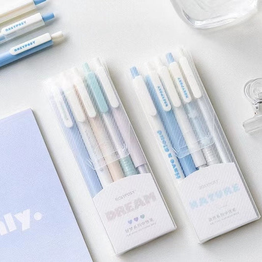 Pastel Quick-Dry Gel Pens - Black Ink, Pack of 5, in light blue and pastel shades packaging, displayed on a white desk with additional stationery items in the background.