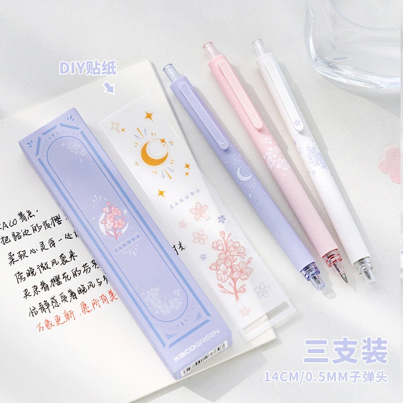 Kawaii Quick-Dry Dual Color Micro Pen set with pastel designs, including purple, pink, and white pens, featuring floral and moon motifs; ideal for cute and functional stationery enthusiasts.