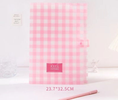 Vibrant gingham button-closure document holder in pink and white checkered pattern, 23.7x32.5cm, labeled "Wave Patterns" on the front, displayed with a pink pen nearby.