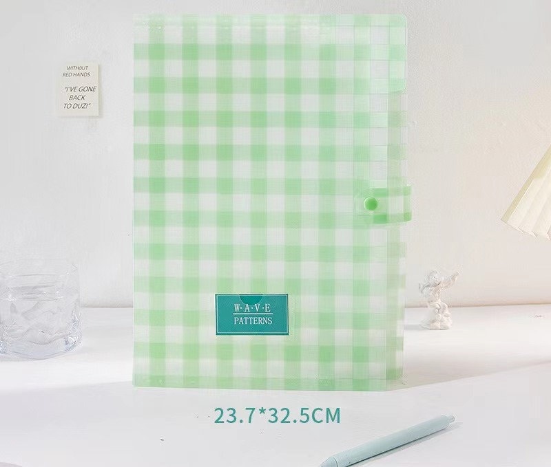 Green and white gingham patterned document holder with button closure, featuring "W.A.V.E Patterns" label. Dimensions are 23.7cm by 32.5cm.