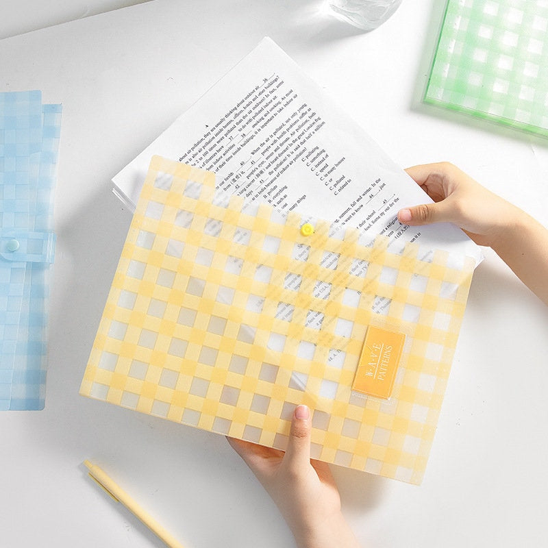 Yellow gingham button-closure document holder with vibrant design, perfect for organizing papers and stationary.